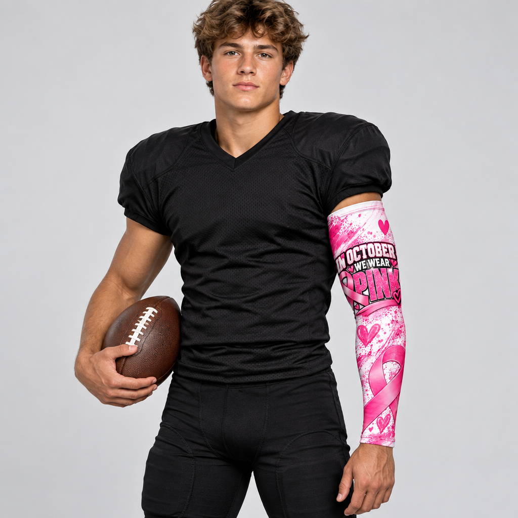 Young football player wearing one pink awareness arm sleeve